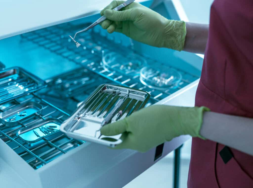 Dentist hands holding dental instruments