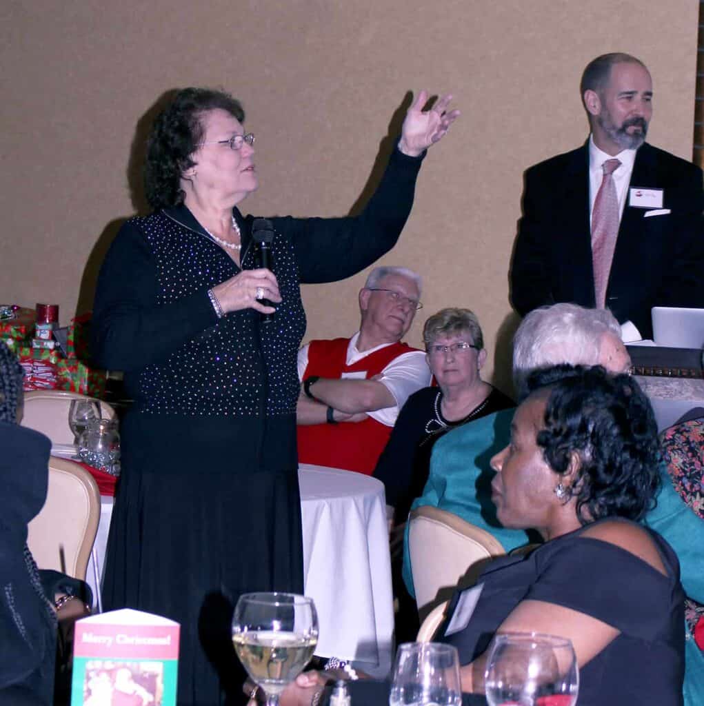 Cherie Wiley conducts festivities at the 2018 holiday celebration.